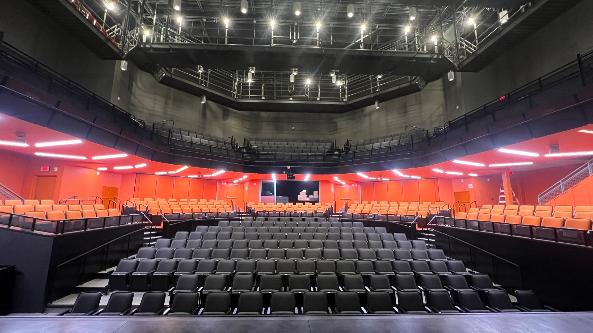 Renovated auditorium from the stage — balcony, catwalk levels, and rear control room.